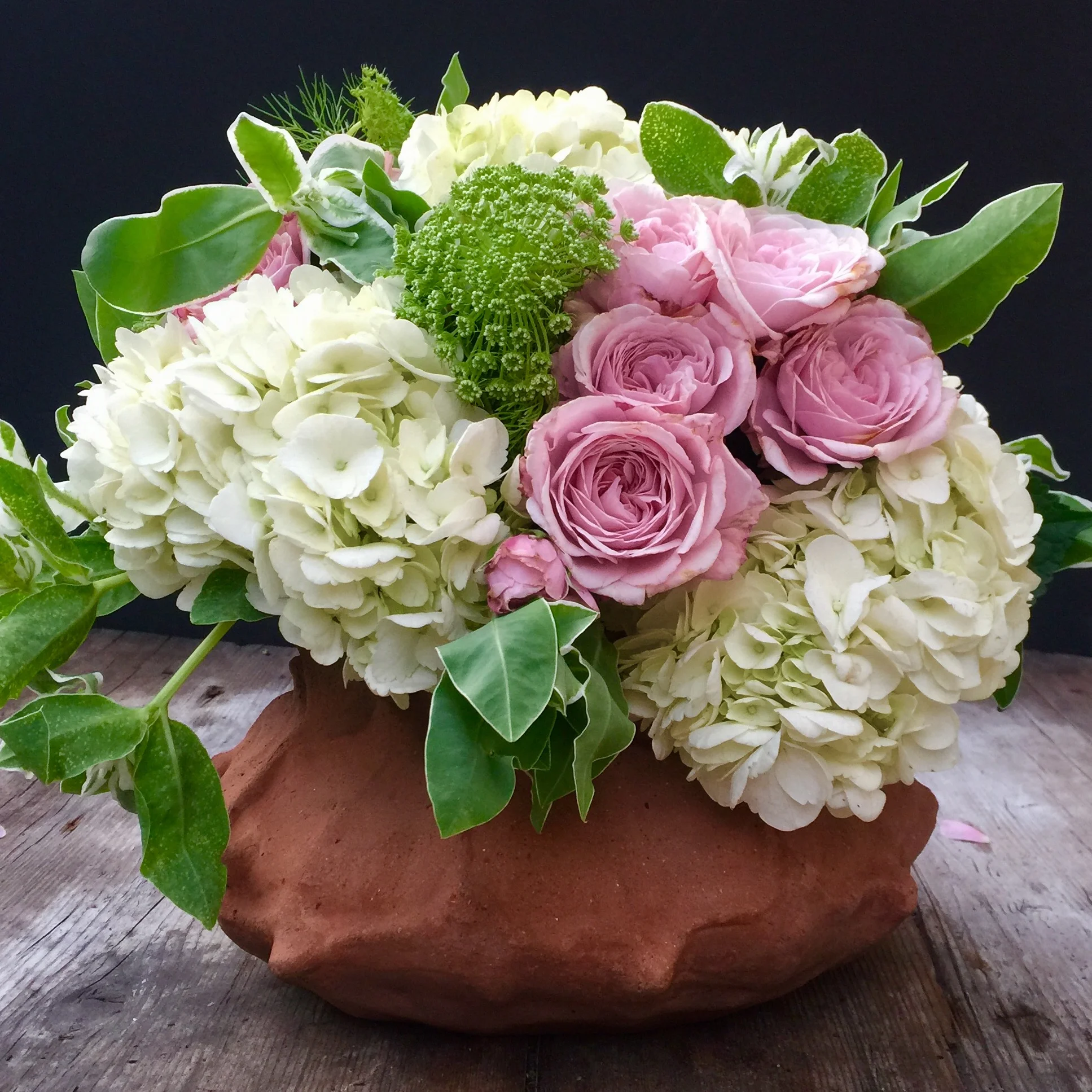 Hydrangea and blush roses in terracotta