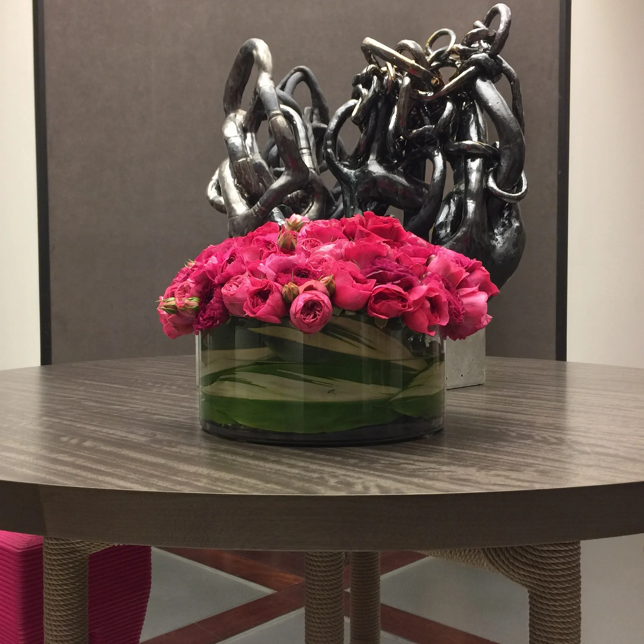Scarlet roses beneath sculpture